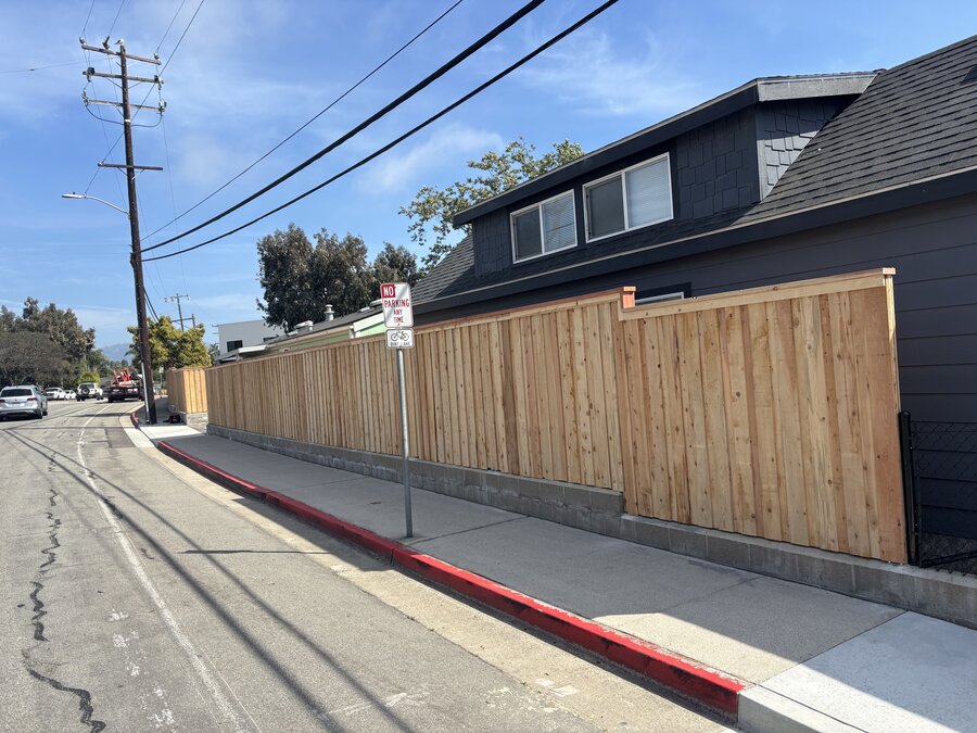 Horizontal cedar gate with house number and keypad entry