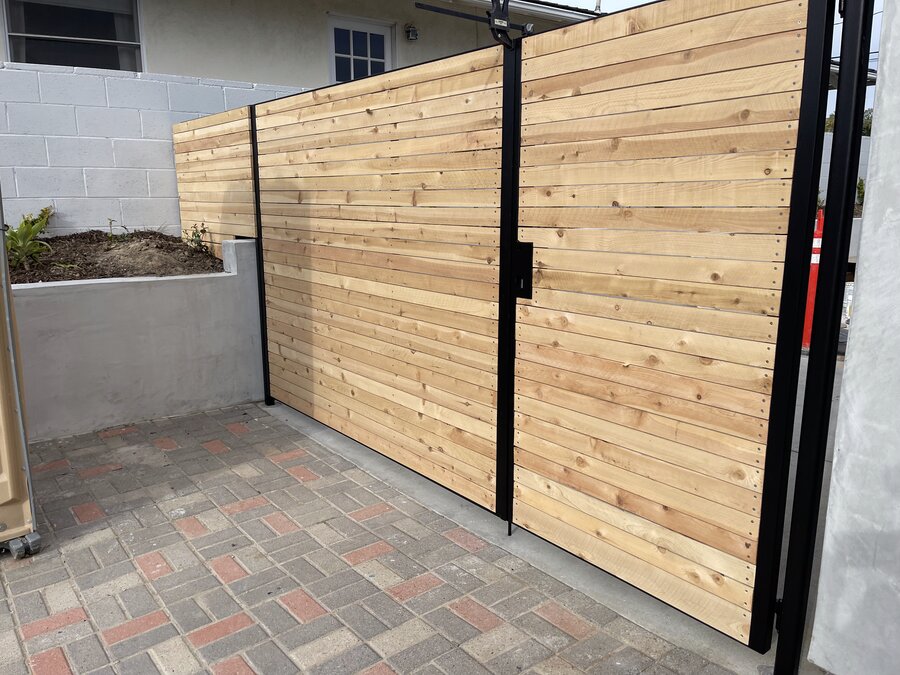 Cedar horizontal-slat gate on a brick paver patio in Montecito