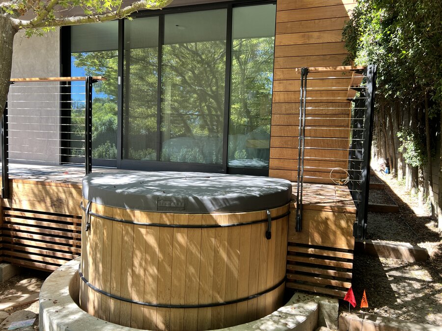 Cedar hot tub with cable-railing deck at a modern Montecito home