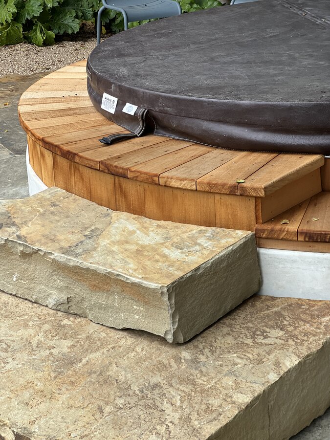 Cedar hot tub deck with natural stone step detail in Montecito