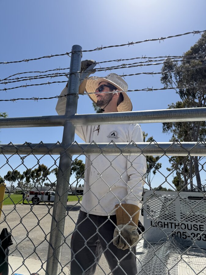 Lighthouse Fence crew installing commercial chain-link and barbed-wire fencing in Goleta