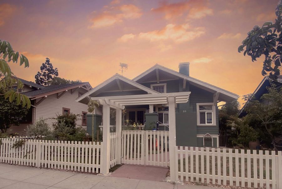 White picket fence and pergola at a craftsman home