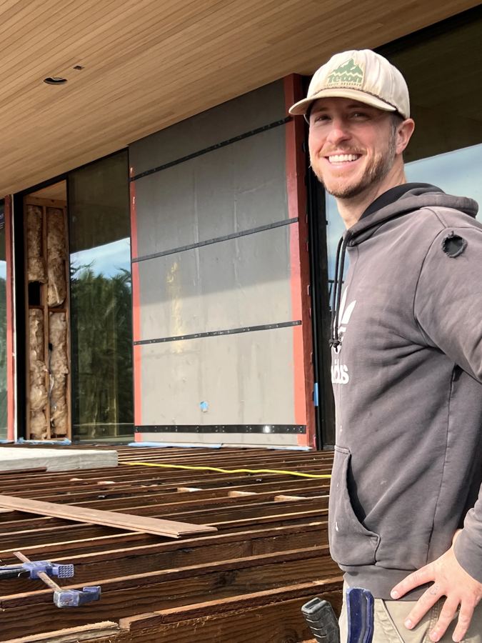 Lighthouse Fence builder smiling on a rooftop deck build