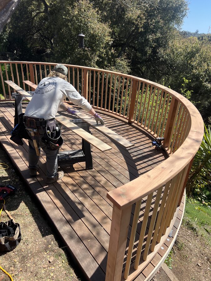 Lighthouse Fence crew building a curved redwood deck and railing in Montecito