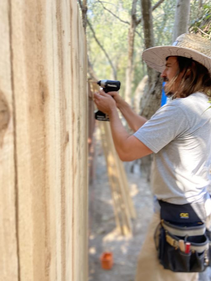 Craftsman replacing fence boards