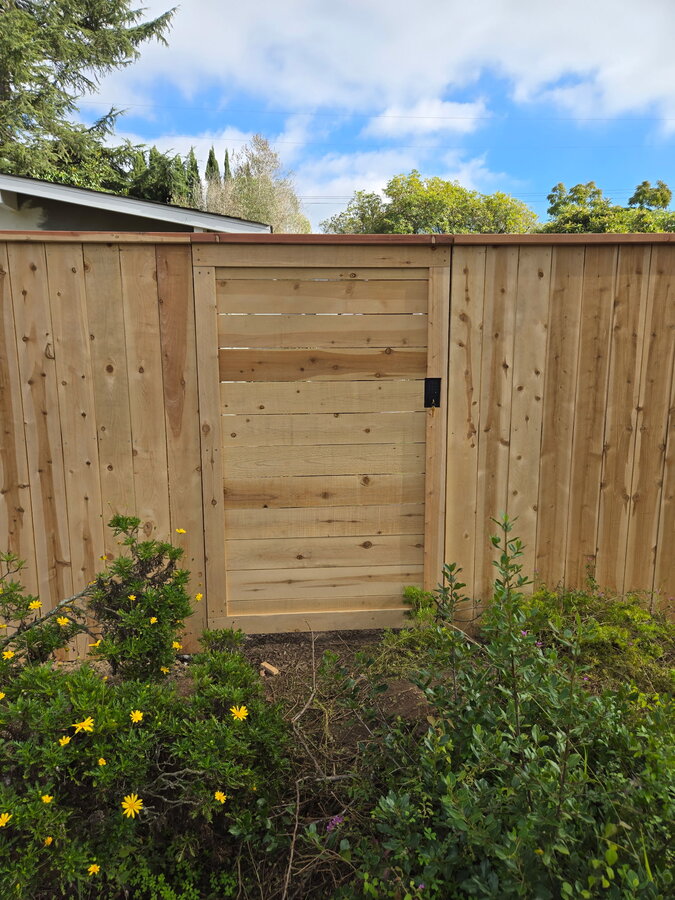 Gray vertical slat aluminum gate on a paver patio in Santa Barbara