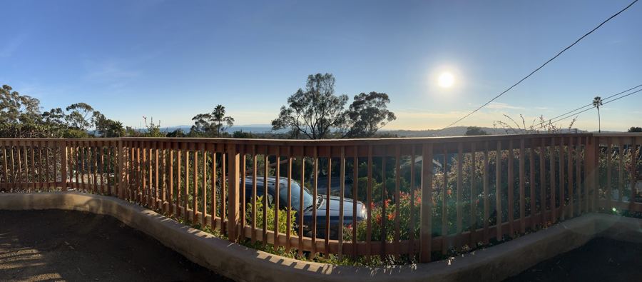 Deck railing overlooking a Santa Barbara hilltop view at sunset