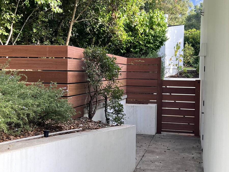 Horizontal tropical hardwood privacy fence and gate in Montecito
