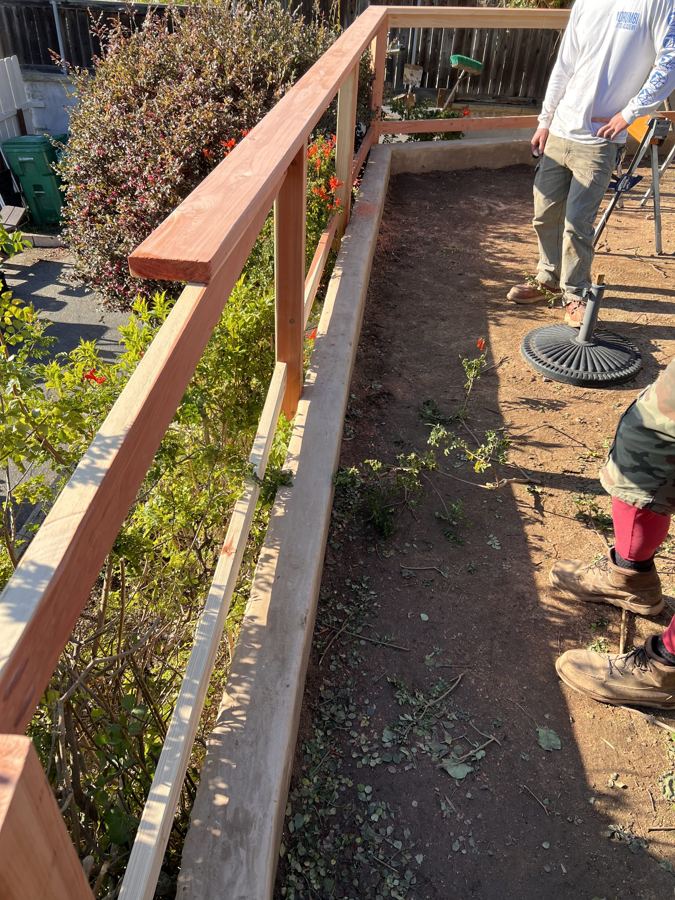 Redwood handrail on a hillside path