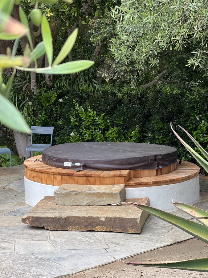 Round cedar hot tub deck in a garden setting in Montecito
