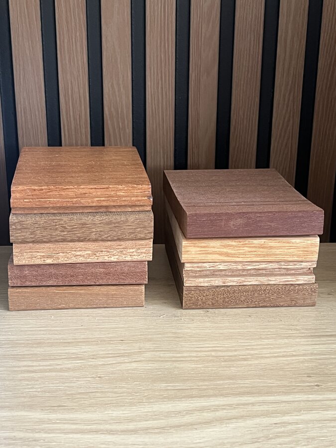 Stacked tropical hardwood samples showing color and grain variation