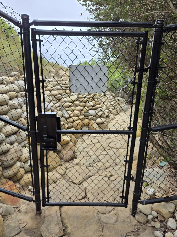 Vertical redwood slat gate with a diagonal brace in Santa Barbara
